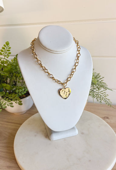 Simple, stylish, and oh-so versatile—this gold chain necklace is the perfect finishing touch for any look. Designed with a textured heart charm, it adds just the right amount of detail and personality without overpowering your outfit. With its adjustable extender, you can wear it closer to the neckline for layering or a little longer on its own. A timeless piece you’ll keep reaching for, no matter the occasion.