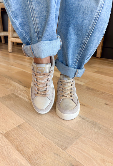 Step into seasonal style with this fresh take on a classic Gola sneaker. Muted gold tones set the stage, while off-white and cerise accents add the perfect pop of contrast. Designed for all-day comfort and everyday wear, this sneaker blends retro charm with modern versatility. Whether paired with denim, dresses, or athleisure, it’s a go-to choice that works across the seasons.