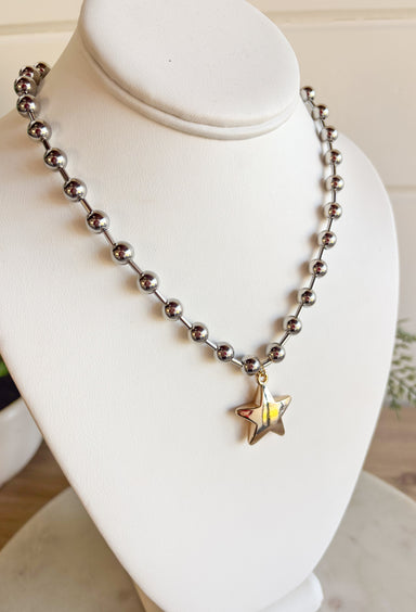 A versatile piece with just the right amount of presence—this silver beaded necklace is finished with a gold star charm that adds a modern, stylish touch. The beaded texture gives it a little extra dimension, making it stand out whether worn solo or layered with other chains. With a lobster clasp and extender, it adjusts easily for the perfect fit, making it an effortless accessory for any outfit or occasion.
