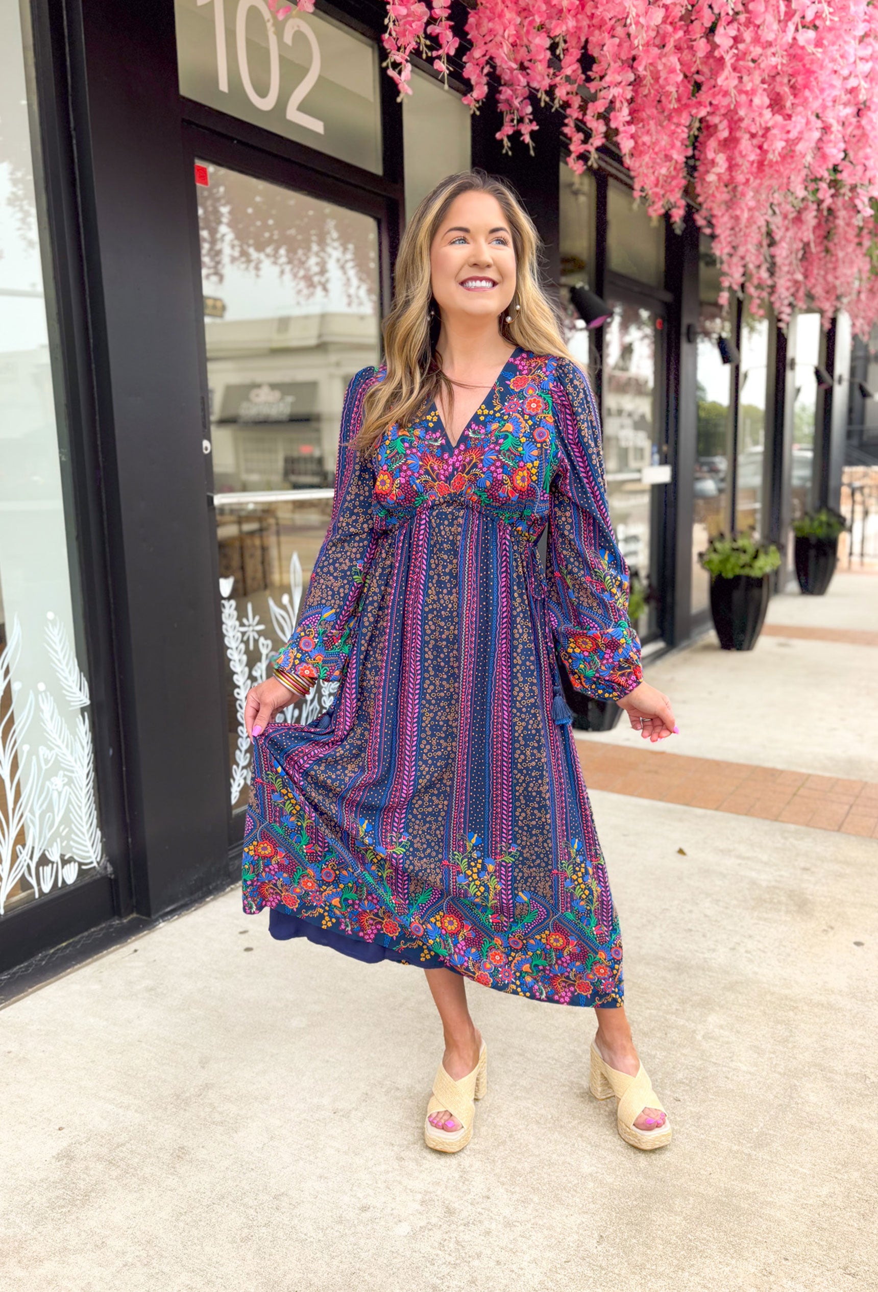 Date Night In Florence Midi Dress, long sleeve midi dress with v-neck. Navy base with red, pink, fuchsia, yellow, green, orange, light blue, and cobalt boho floral pattern