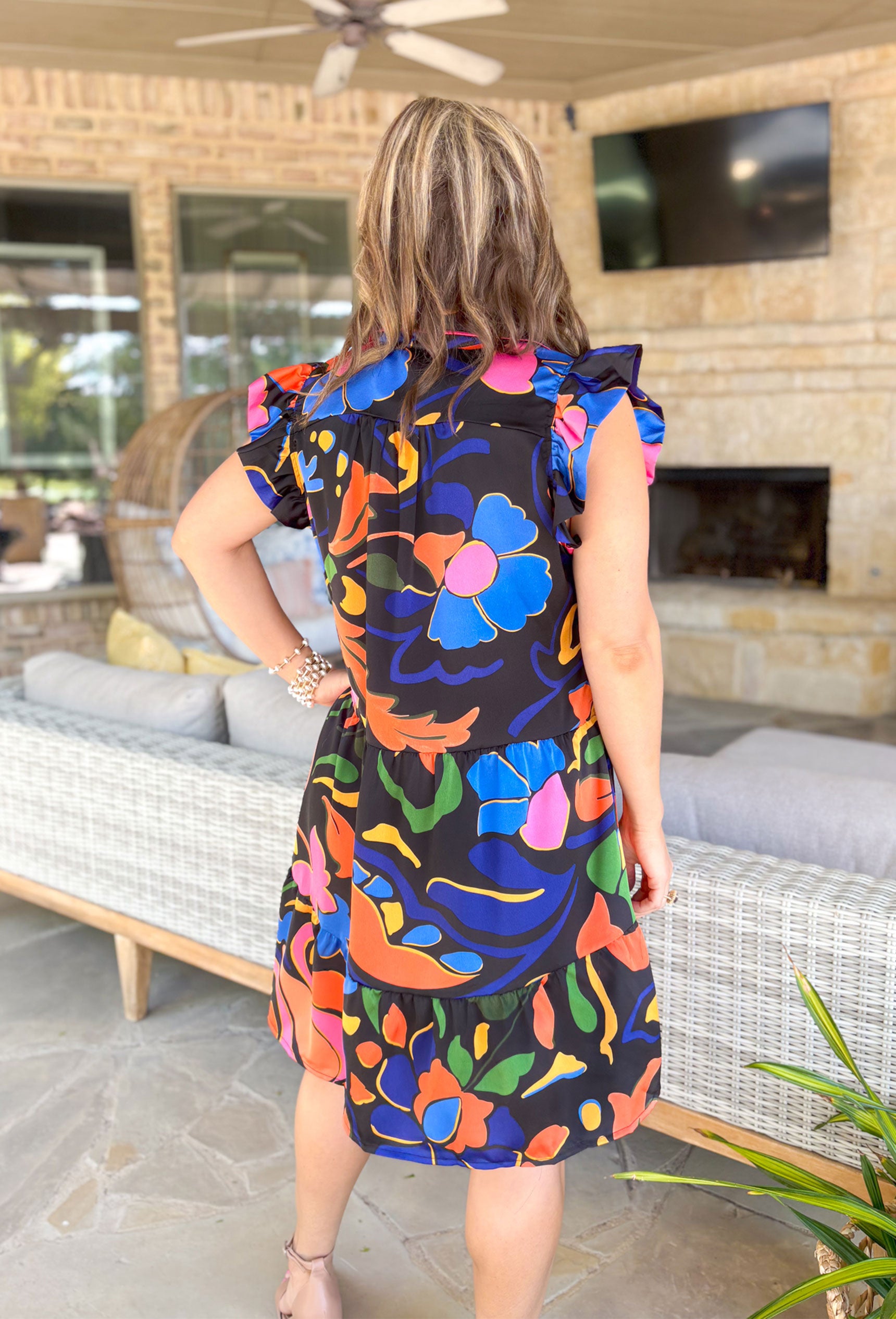 Room To Bloom Floral Dress, black ruffle sleeve tiered dress with v-neck with orange, pink, royal blue, yellow, and green abstract floral print 
