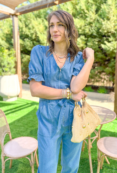 Southern Beauty Denim Jumpsuit, short puff sleeve denim jumpsuit with ruffling on the sleeves, soft v-neck, zipper down the front, tie belt at the waist, and pockets