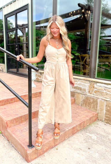 Stroll Through Capri Jumpsuit, beige spaghetti strap jumpsuit with wide legs, pockets, buttons down the chest, and cinching in the back 