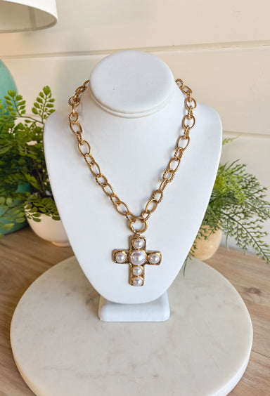 This chunky gold chain necklace makes a bold yet timeless statement. Featuring a gold cross adorned with pearls, it blends modern edge with classic elegance. The toggle clasp closure adds a stylish touch while keeping it easy to wear. Perfect for elevating casual looks or adding a refined accent to dressier outfits.