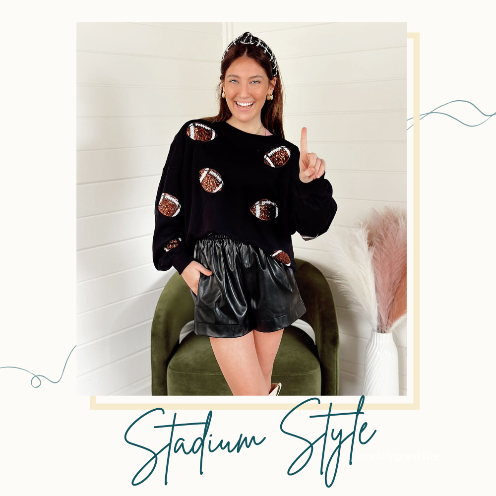 Shop our Stadium Style Collection: Model wearing a black oversized pullover with sequins footballs in brown and white styled with faux leather shorts, a black and white tweed headband and boots.