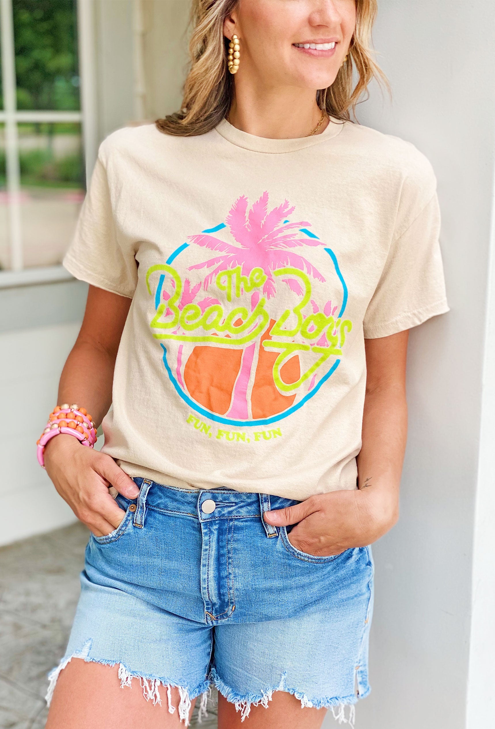 Neon Beach Boys Graphic Tee,  Neutral tee with a bold and bright neon design that reads "The Beach Boys" and a classic palm tree motif