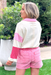 Best Days Ahead Pullover, White terry cloth pullover by entro with a collared neck and panels of pink and red fabric. Styled with pink denim elastic waist shorts and gold sandals.