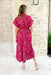 Catching Feelings Midi Dress, abstract lines midi  short sleeve dress with a cinched waist line and cuffed sleeves. Colors are magenta, fuchsia, cranberry, yellow, and cream 