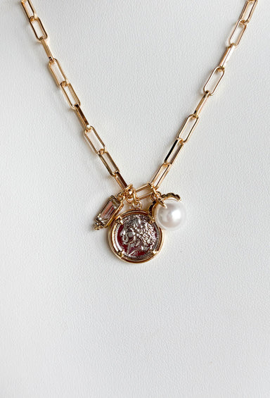 First Glances Necklace in Gold, gold paper clip chain necklace with rhinestone, coin, and pearl charm in the center