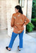 In The Wild Blouse, Satin button up caramel blouse with cheetah graphics. Cuff sleeve detailing with snap straps to hold cuff in place