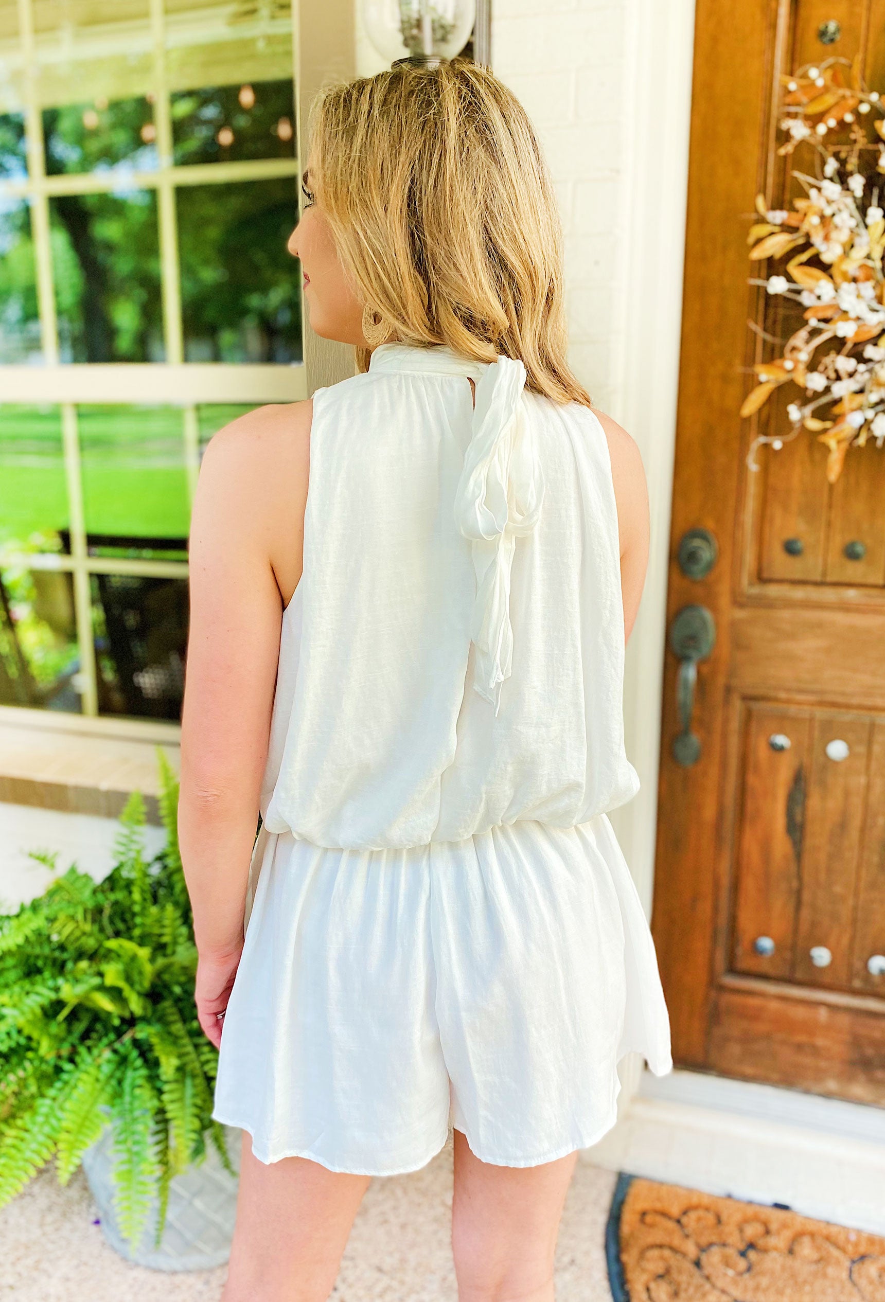 In Your Dreams Romper, white halter top and an alluring open back, White romper with a neutral acrylic chain detail across the front and an open back