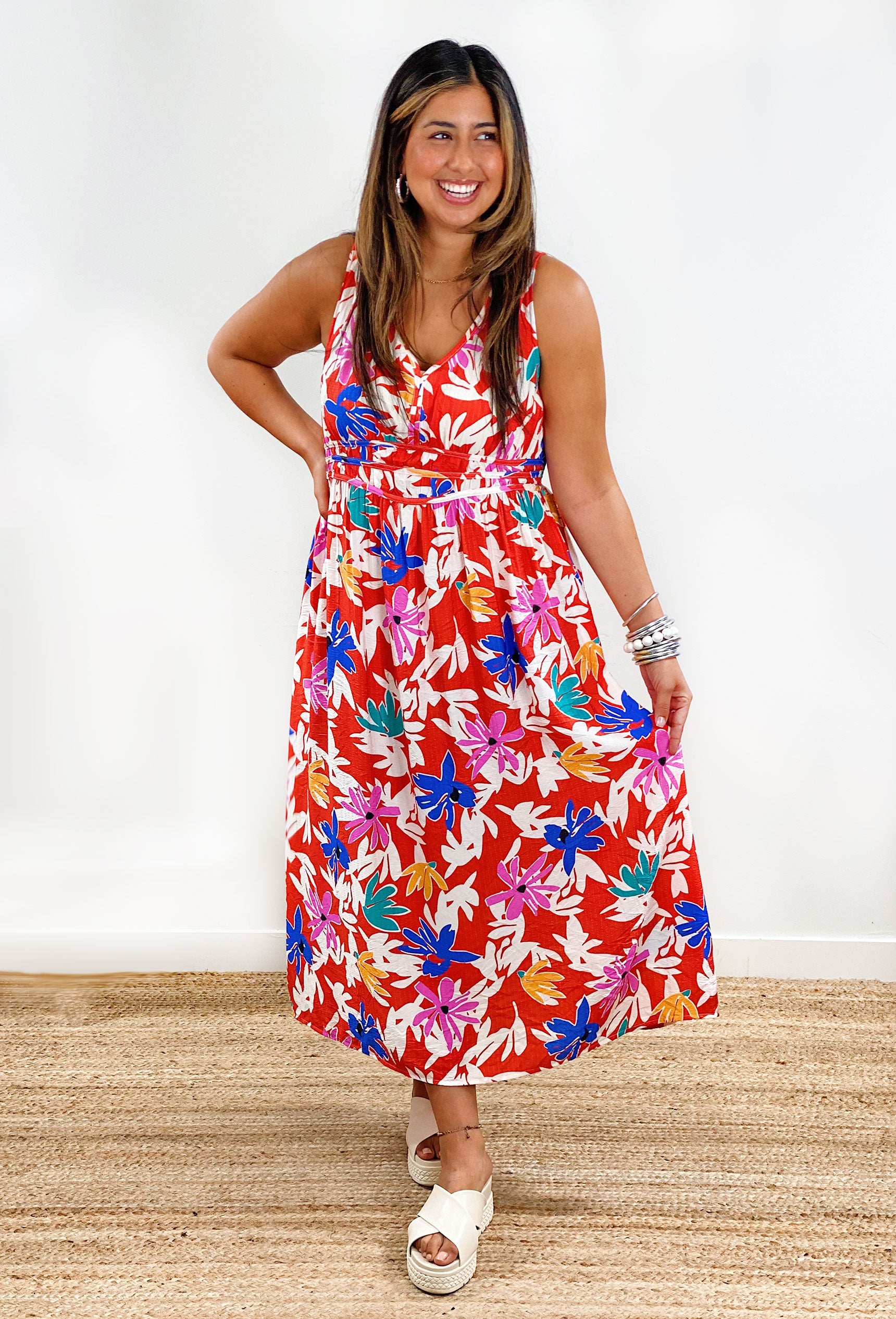 Island bloom midi dress. Red dress featuring a floral print with pops of color and a v-neck line.