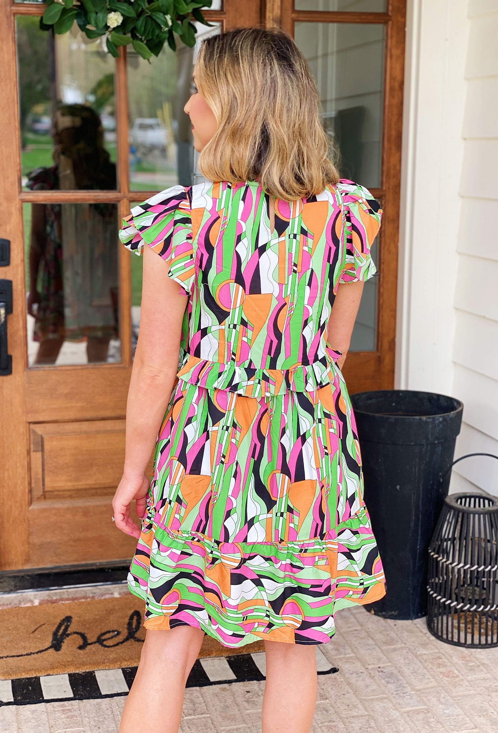 Malibu Mindset Dress, abstract print and unique details like ruffled sleeves and a front ruffle overlay