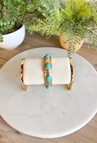 Add a touch of color and shine to your look with this gold bracelet featuring turquoise stones all around. Designed in a pull-on style for easy wear, it’s lightweight, versatile, and the perfect finishing piece for both casual and dressier outfits. With its timeless mix of gold and turquoise, this bracelet is one you’ll reach for season after season.