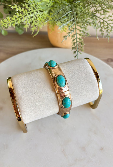 Add a touch of color and shine to your look with this gold bracelet featuring turquoise stones all around. Designed in a pull-on style for easy wear, it’s lightweight, versatile, and the perfect finishing piece for both casual and dressier outfits. With its timeless mix of gold and turquoise, this bracelet is one you’ll reach for season after season.