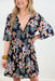 Midnight Garden Floral Dress, Black mini dress featuring a vibrant floral print and a V neckline