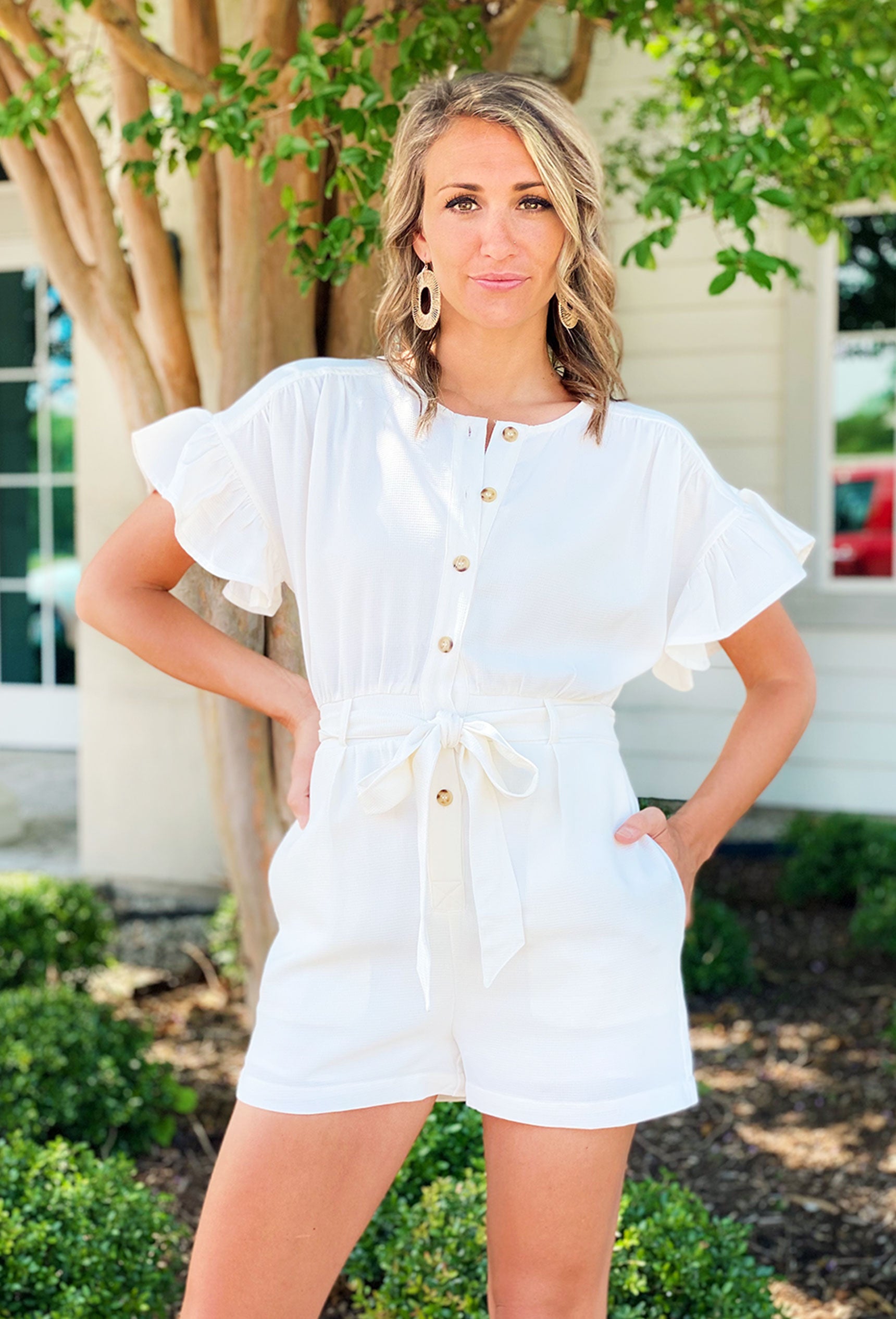The Coast Is Calling Romper. Soft white fabric with a subtle texture, White romper with tortoise shell buttons and a matching belt.