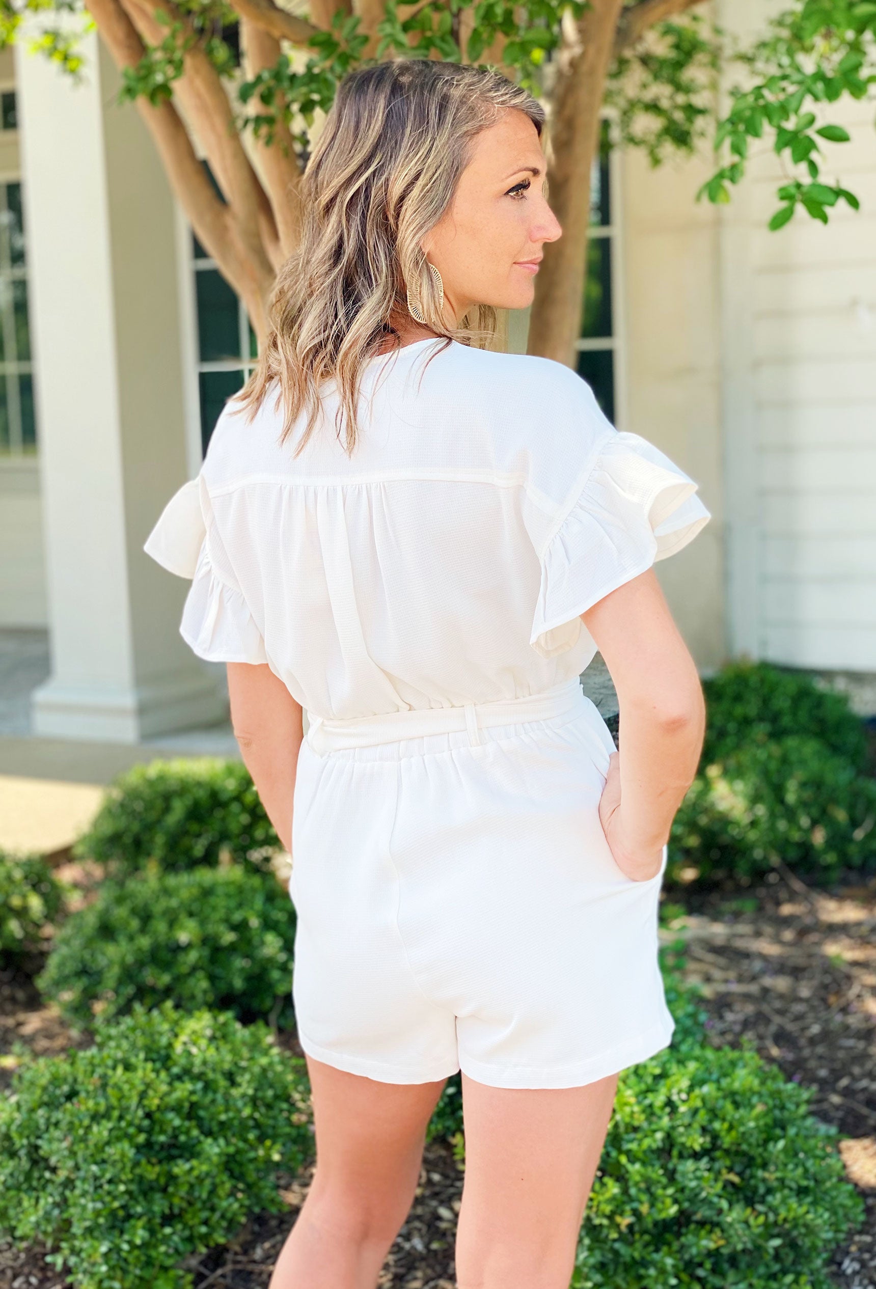 The Coast Is Calling Romper. Soft white fabric with a subtle texture, White romper with tortoise shell buttons and a matching belt.