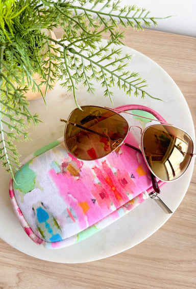 The Giverny Laura Park Neoprene Sunglass Case, sunglasses pouch with zipper in the "giverny" pattern in the colors bubblegum pink, hot pink, cranberry, off white, teal, lime, orange, tan, and seafoam