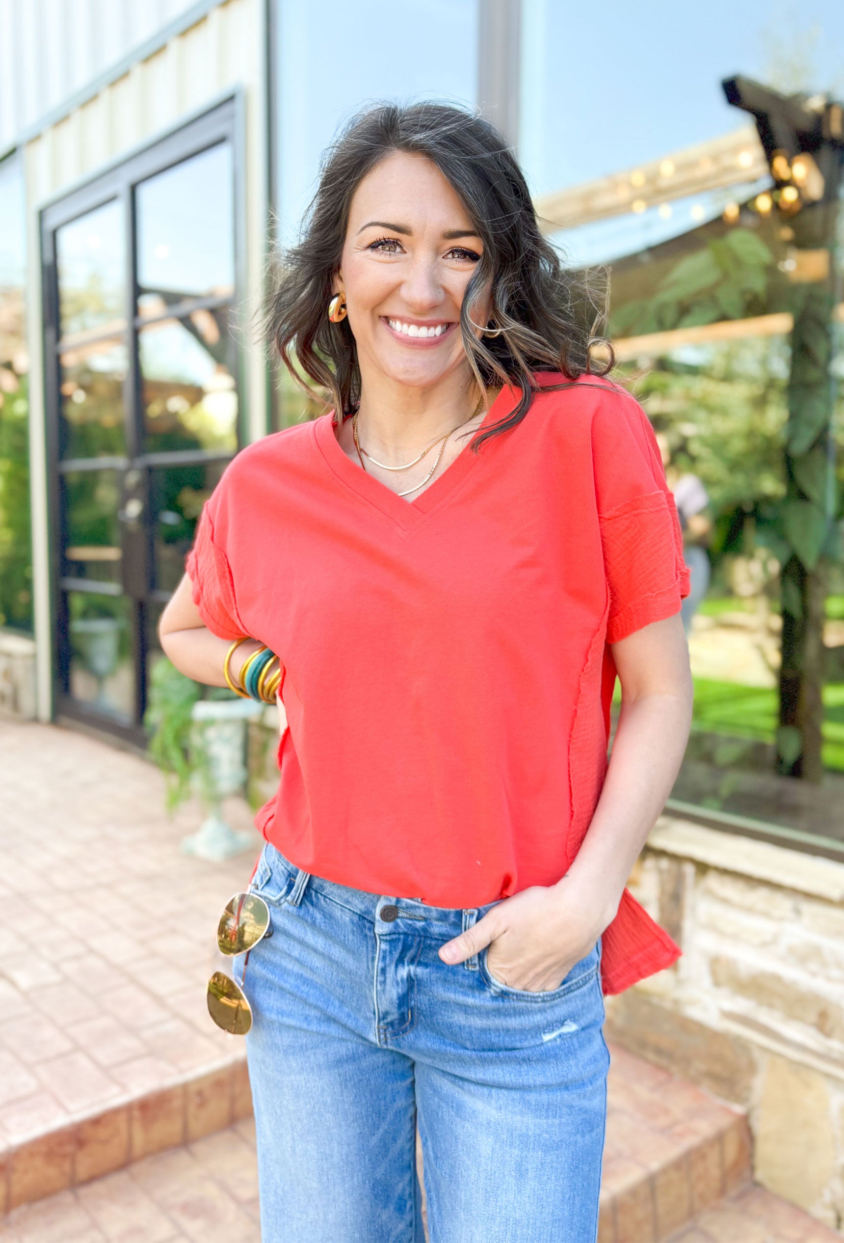 All It Takes Top, cotton short sleeve t-shirt with slight v-neck in the color tomato orange with gauze siding an at the bottom of the sleeves