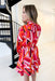 Always Stand Out Dress, red, pink, orange, burgundy, and white abstract line dress with long sleeves, high neck, and tie detail on the back of the neck