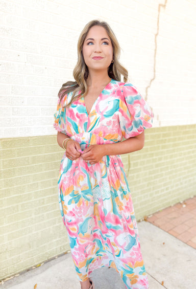 Anything For You Maxi Dress, short puff sleeve maxi dress with abstract floral print on it in the colors teal, yellow, pink and white.V-neck and cinching on the waist