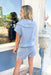 Back On Track Set, light blue grey scuba material short sleeve top and shorts set. Quarter zip down, elastic waist with drawstring and pocket