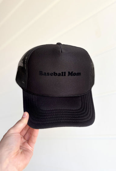 Baseball Mom Trucker Hat, all black trucker hat with black velvet font "baseball mom" on the front. monochrome