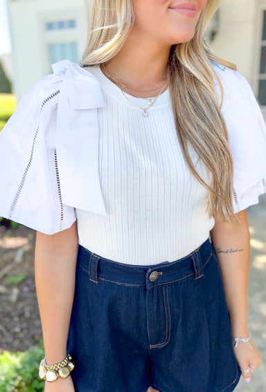 Call It Chic Top, white ribbed top, blouse sleeves with lace details, large white bows on top of each shoulder 