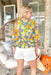 Everything Has Changed Floral Top, quarter sleeve blouse, v-neck, floral print in yellow, orange, pink, and green with electric blue base, ruffle detailing on the bottom of the shirt