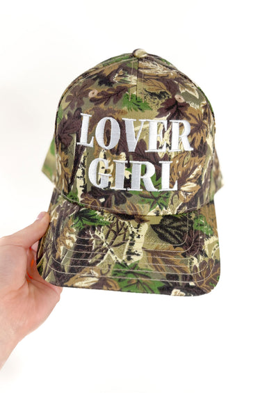 Friday + Saturday: Lover Girl Trucker Hat, natural camo hat with embroidered words "lover girl" in the center of the hat