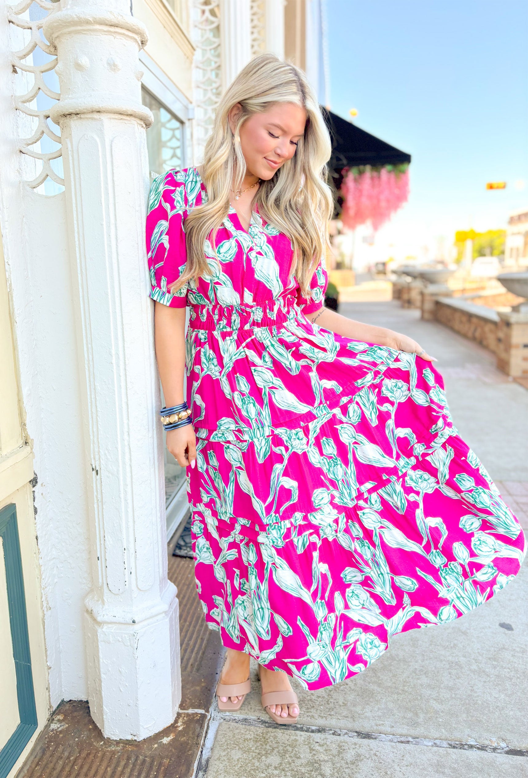 Garden Strolls Midi Dress, hot pink short sleeve midi dress white and green tulip design on the whole dress, cinching on the waist, v-neck line, and tiering on the bottom half of the dress