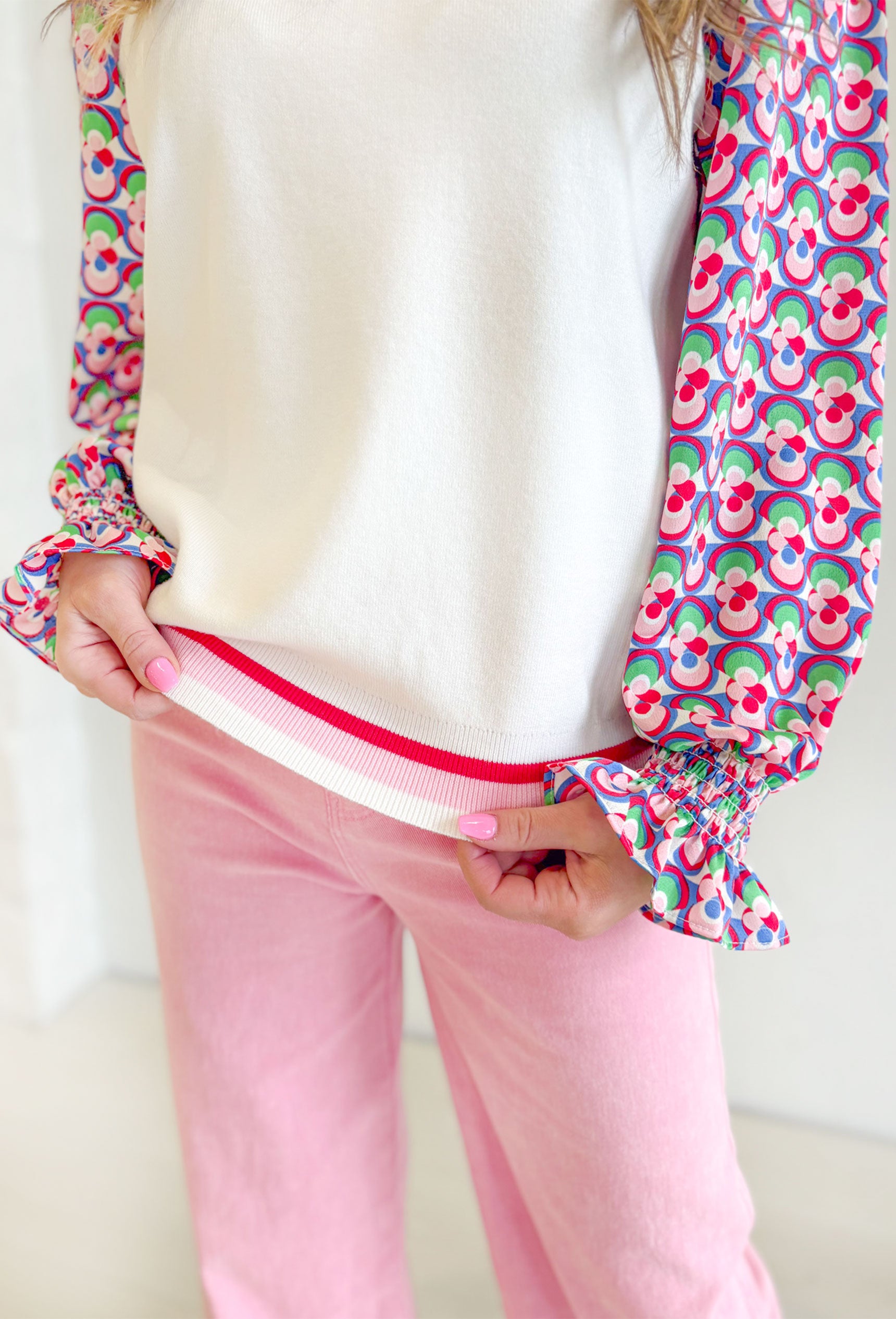 Gather The Courage Top, white sweater top with thin patterned sleeves in the colors red, pink. green, white, and blue