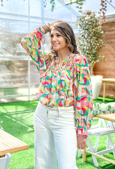 Keep Me Company Blouse, long sleeve blouse with cinching on the chest, sheer sleeves, ruffling on the wrist, and an abstract print in the colors red, kelly green, lime green, cream, pink, and seafoam 