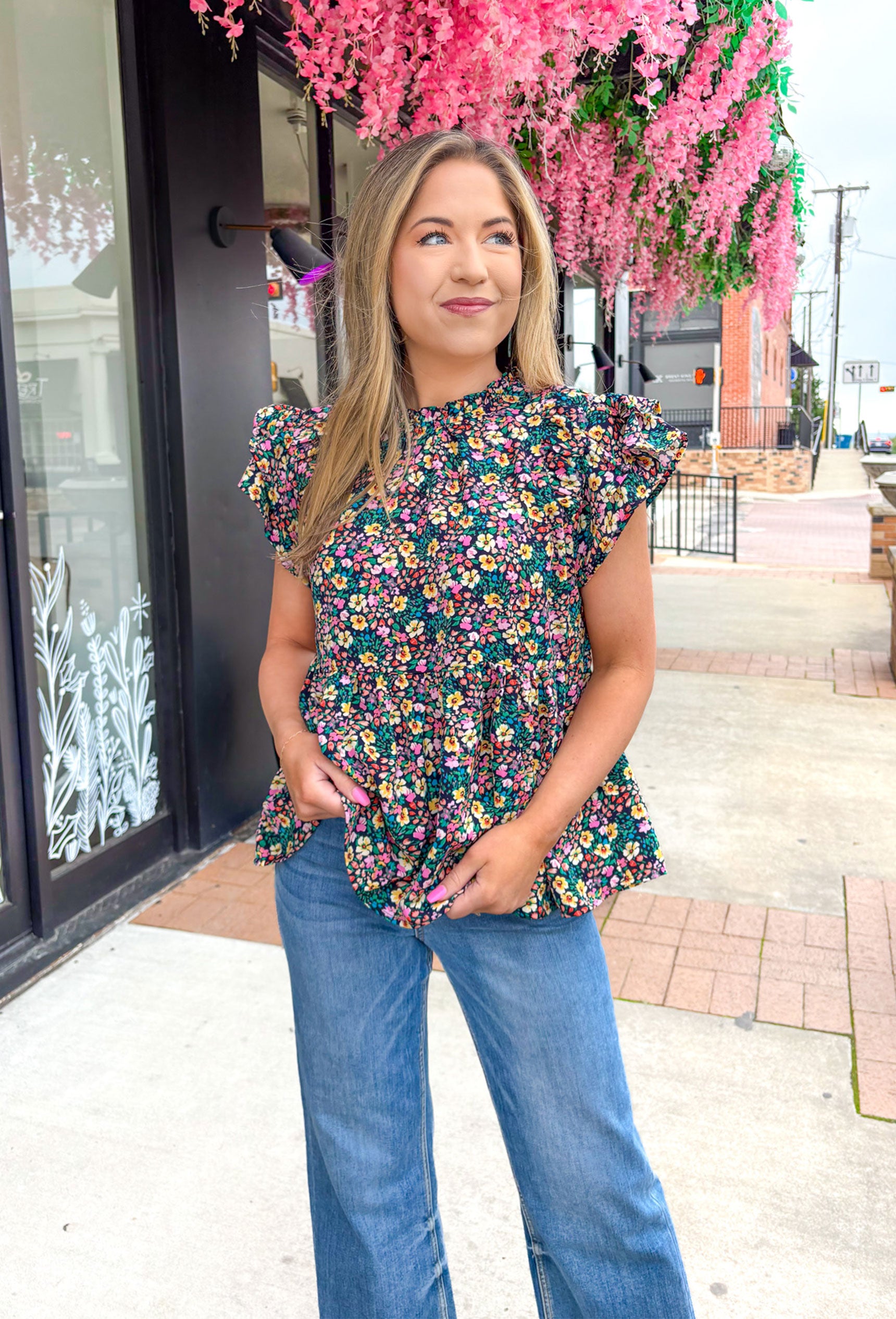 Love Again Floral Babydoll Top, short ruffle sleeve baby doll blouse with small floral print in the colors navy, pink, orange, yellow, and green