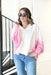 Make It Right Pullover, oversized pullover with collar and slight v-neck. chest is white, shoulder and sides are white and pink striped and the bottom of the sleeves are pink 
