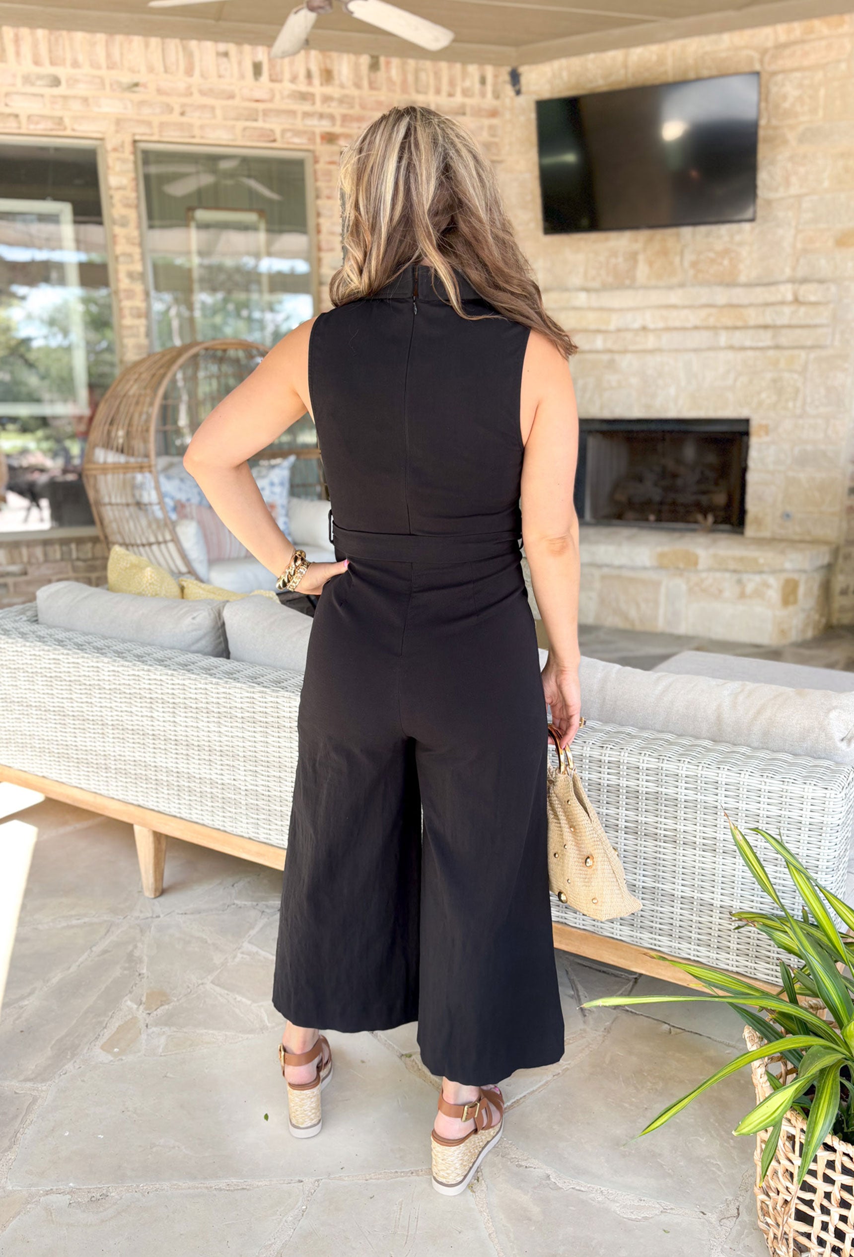Midnight In London Jumpsuit, black sleeveless wide leg jumpsuit with collar, sailor pocket, and tie detail around the waist