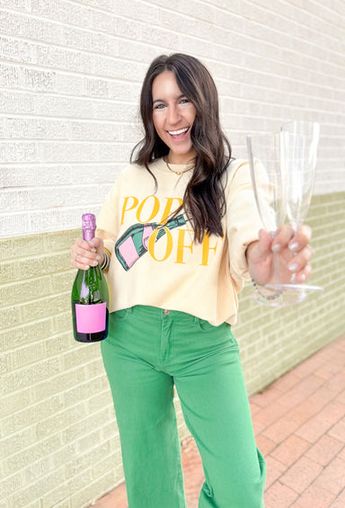 Friday + Saturday: Pop Off Corded Pullover, tan corded crew with graphic on the front "pop off" in yellow and a champagne bottle in pink and green