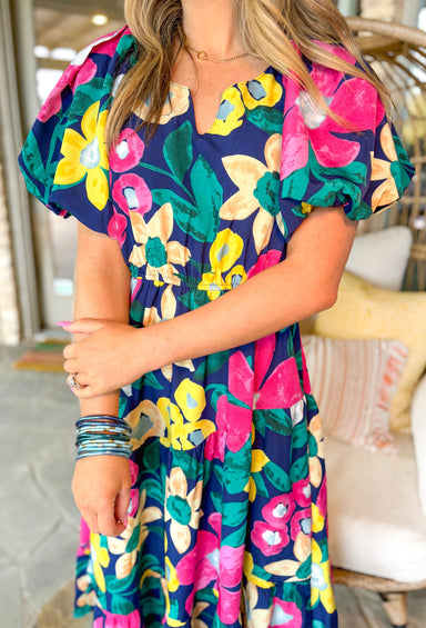 Brunch In Nashville Floral Midi Dress, navy short puff sleeve midi dress with pink, yellow, green, and light blue floral print