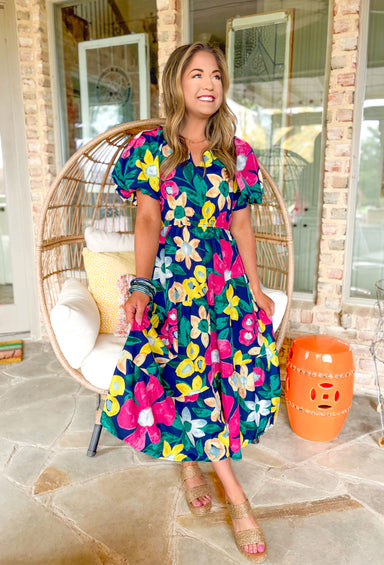 Brunch In Nashville Floral Midi Dress, navy short puff sleeve midi dress with pink, yellow, green, and light blue floral print