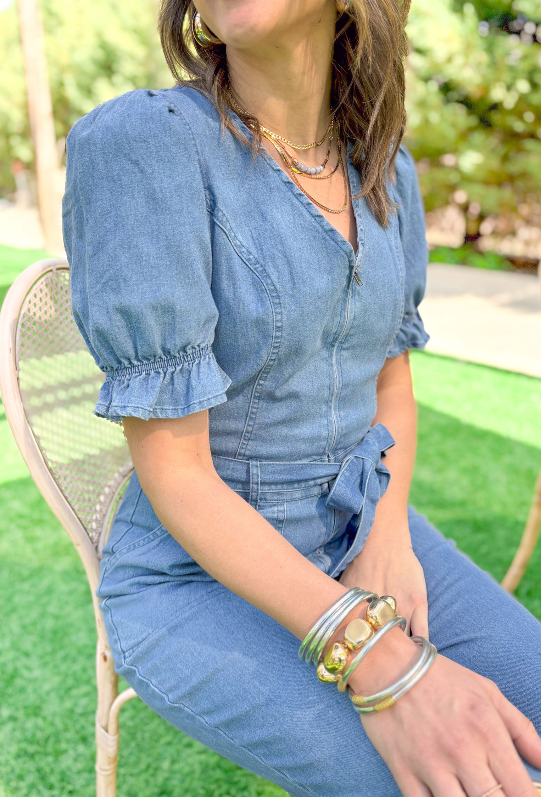 Southern Beauty Denim Jumpsuit, short puff sleeve denim jumpsuit with ruffling on the sleeves, soft v-neck, zipper down the front, tie belt at the waist, and pockets