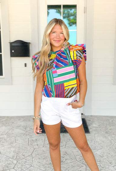 St. Tropez Stroll Blouse, abstract rectangle ruffle sleeve blouse high neck line with ruffling around the edge, colors are yellow, blue, red, green, light pink, hot pink, orange, dark green, light blue