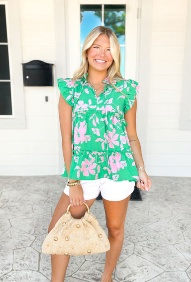 Summer Romance Floral Blouse, flutter sleeve tiered blouse with ruffles around the neck and on each tier, kelly green base with bubble gum pink floral print 