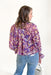 Take Your Chance Blouse, abstract flower long sleeve blouse with cinch and ruffle detailing on the wrists and a slight v-neck