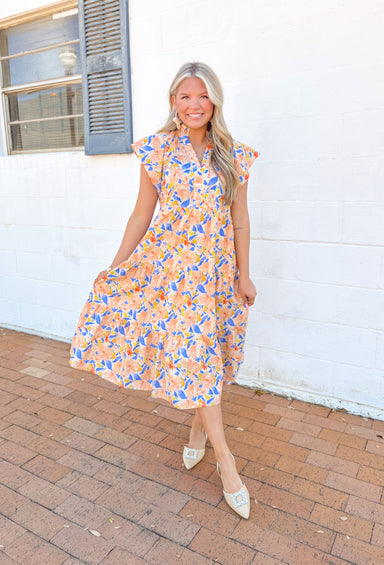 Wishing For Florals Midi Dress, ruffle sleeve v-neck tiered midi dress with orange, blue, yellow, and tomato red floral pattern, ruffling around the neck, and pockets 