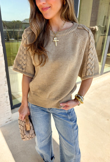 Cozy meets casual in this oatmeal sweater top, perfect for those in-between fall days. Designed with short raglan sleeves and a braided sleeve detail, it brings just the right amount of texture to your outfit. The ribbed hem, cuffs, and neckline give it a classic sweater finish, while the soft knit blend makes it comfortable for all-day wear. Easy to pair with jeans, skirts, or layered under a jacket, this is a versatile staple you’ll reach for again and again.