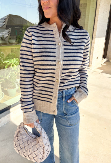 This tan and navy striped cardigan is giving all the cozy fall feels! With its classic button-down front and comfy knit blend, it’s the kind of layering piece you’ll reach for again and again. Whether you’re apple-picking or just couch-cuddling, this one’s ready to wrap you in warmth and style.