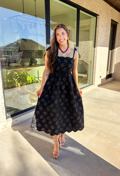 When the invite calls for dressy but you still want to feel comfortable, this is the dress. In classic black with a subtle gold floral texture that feels lace-like, it’s a showstopper without being over the top. The scalloped neckline and hem add a romantic finish, while the self-tie straps let you adjust for the perfect fit. Whether you’re attending a wedding, holiday party, or a candlelit dinner, this midi is a timeless choice you’ll wear for seasons to come.