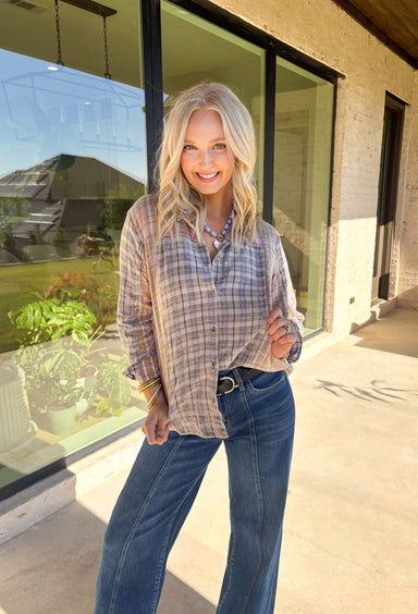 A timeless favorite with a cozy fall twist—this plaid flannel by Mystree is as versatile as it is comfortable. Designed in a mix of neutral shades with subtle pops of gray, light pink, light blue, tan, and off-white, it’s easy to pair with just about anything in your closet. The button-down design and collared neckline keep it classic, while the 100% cotton fabric makes it breathable and soft for all-day wear. Perfect for layering or styling solo, this flannel will be your go-to through the season.