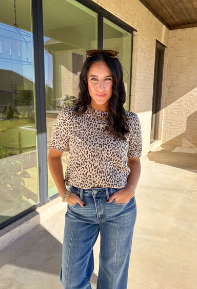 This taupe lightweight knit sweater by Fate brings effortless style to your fall wardrobe. Designed with a black leopard print, it adds a playful touch while keeping things easy and chic. The short sleeves and ribbed hem, neckline, and sleeves give it a polished finish, making it perfect for layering or wearing solo on those in-between days.